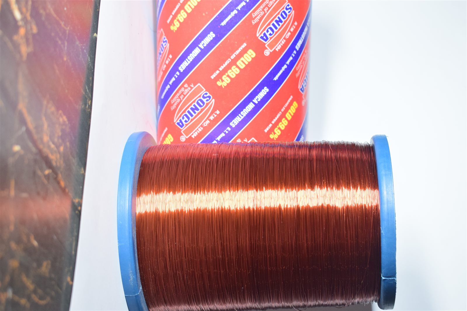 Gold 99.9% enameled copper wire spool angled view